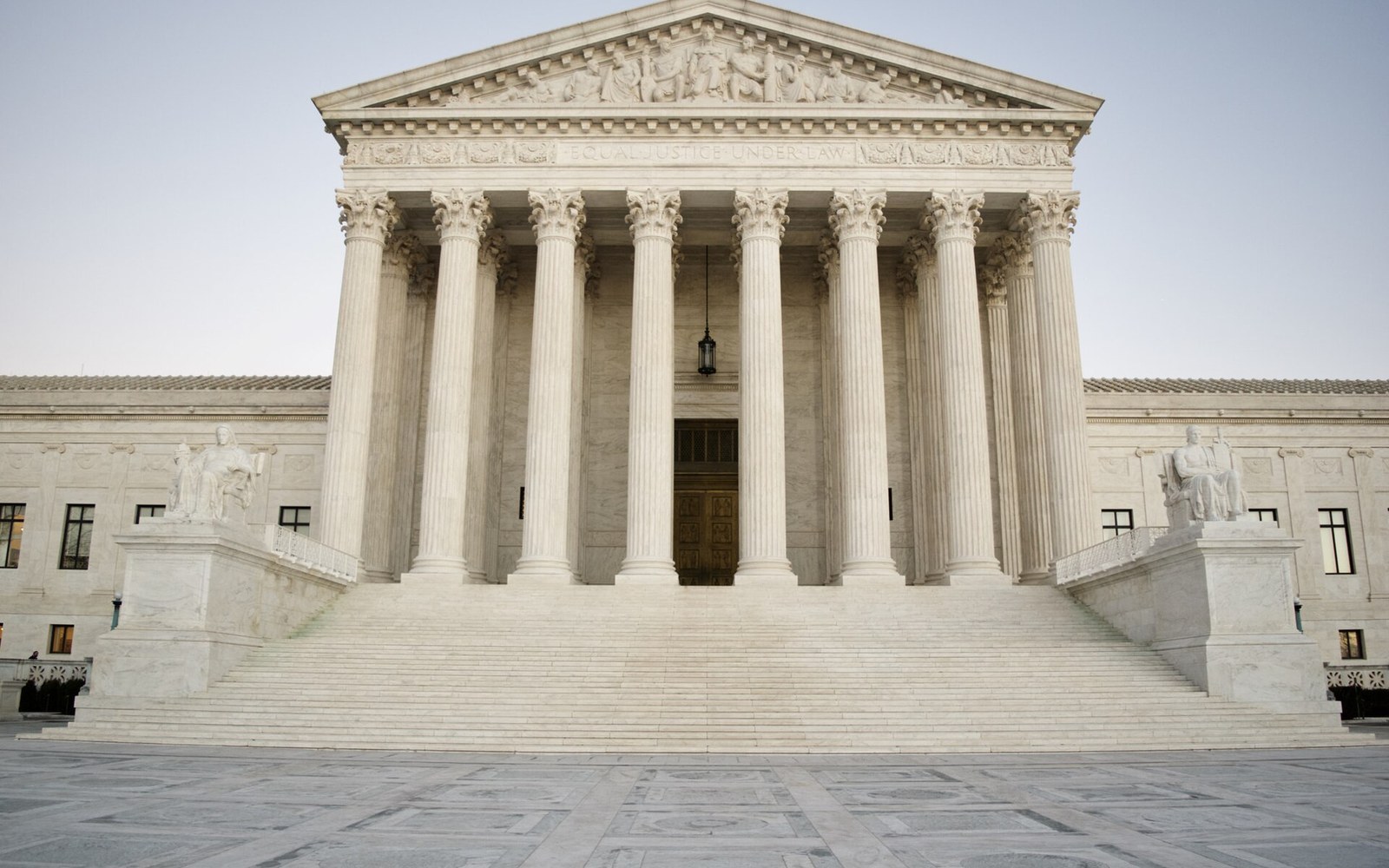 Front facade of the US Supreme Court building with its columned portico and marble steps