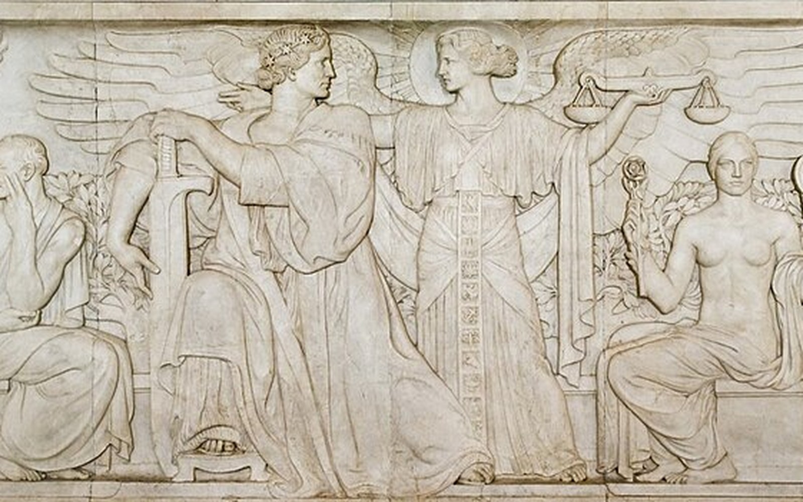 Marble frieze depicting robed allegorical figures, one holding a sword and another a scale