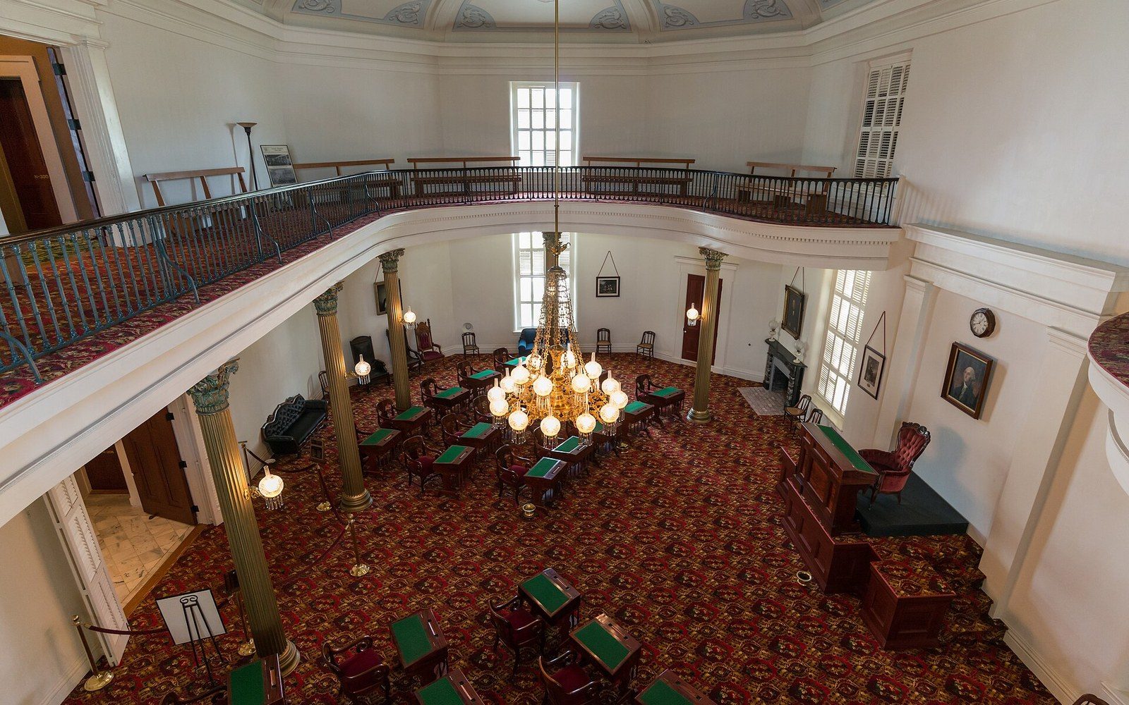 The United States Senate chamber photographed from the gallery, desks empty, the presiding officer's dais visible